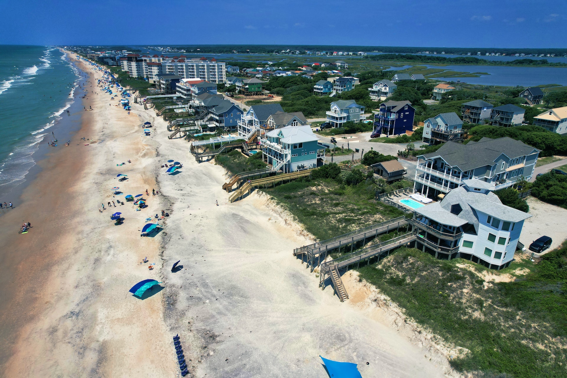 An aerial view of a beach with several houses