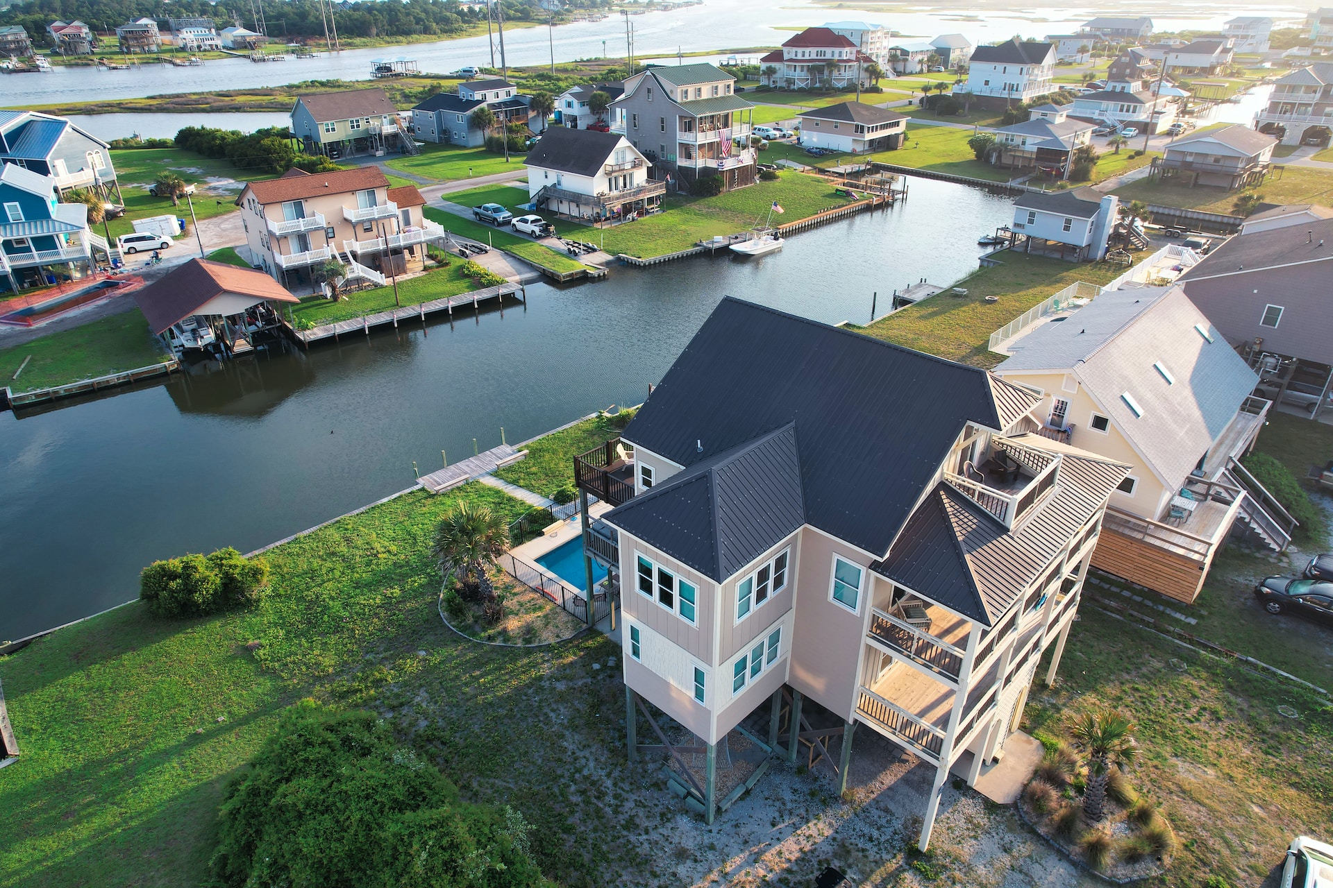 An aerial view of a house on the water