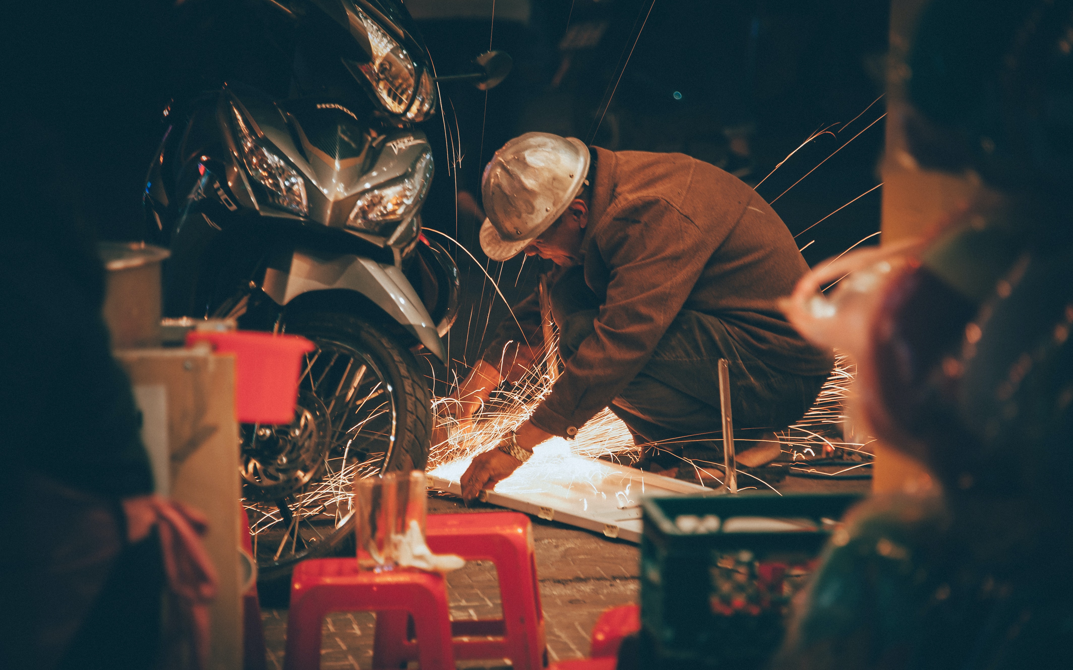 Image of a man working on a motorcycle